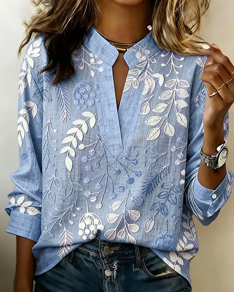 BLUSA CON ESTAMPADO FLORAL Y CUELLO ALTO