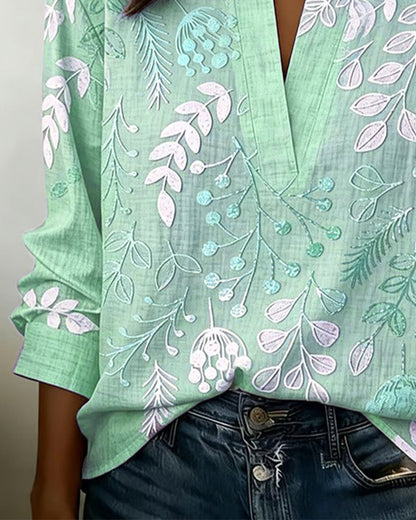 BLUSA CON ESTAMPADO FLORAL Y CUELLO ALTO