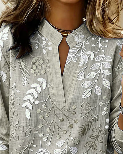 BLUSA CON ESTAMPADO FLORAL Y CUELLO ALTO