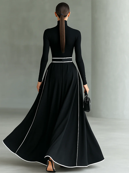 VESTIDO LARGO NEGRO CON COSTURAS BLANCAS, CUELLO ALTO Y MANGA LARGA