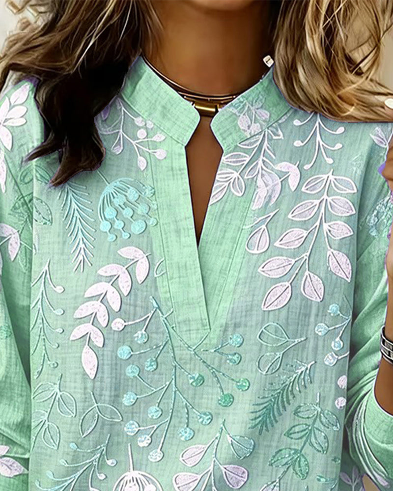 BLUSA CON ESTAMPADO FLORAL Y CUELLO ALTO