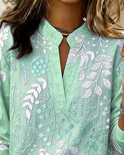 BLUSA CON ESTAMPADO FLORAL Y CUELLO ALTO