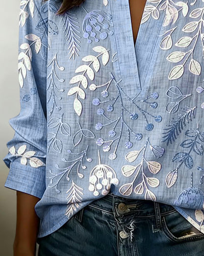 BLUSA CON ESTAMPADO FLORAL Y CUELLO ALTO