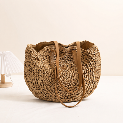 LINDA | BOLSO REDONDO DE PAJA TRENZADA - AVELLANA