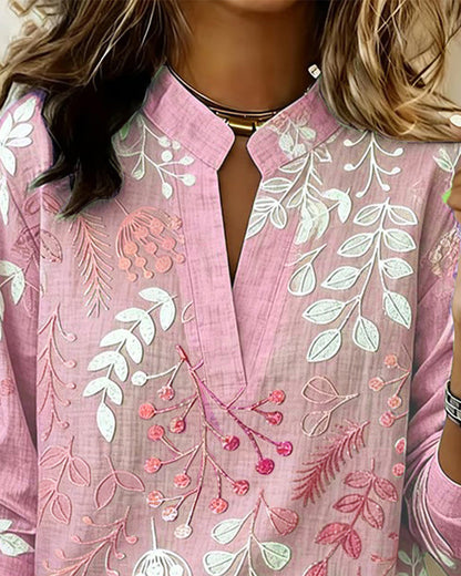 BLUSA CON ESTAMPADO FLORAL Y CUELLO ALTO