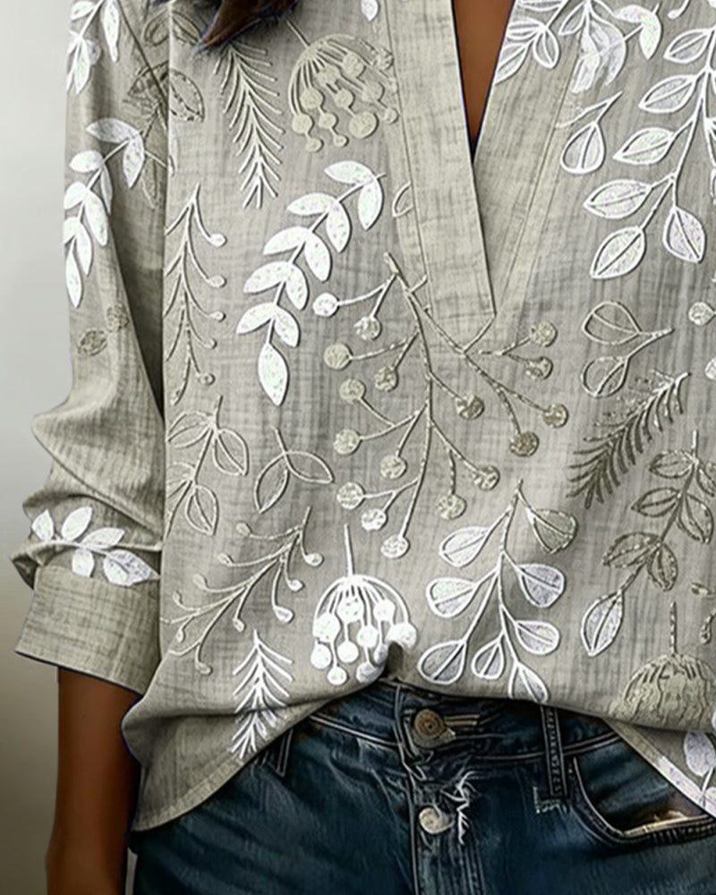 BLUSA CON ESTAMPADO FLORAL Y CUELLO ALTO