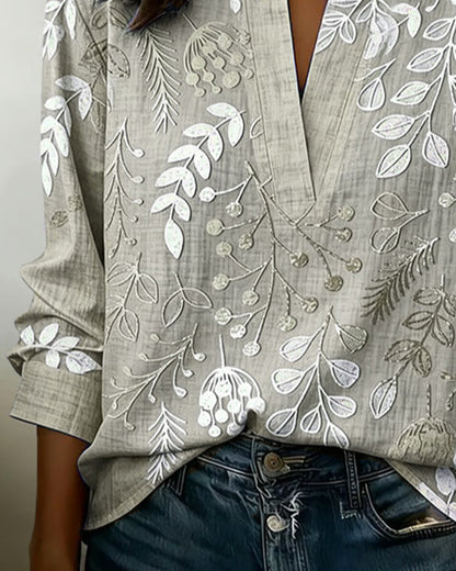 BLUSA CON ESTAMPADO FLORAL Y CUELLO ALTO