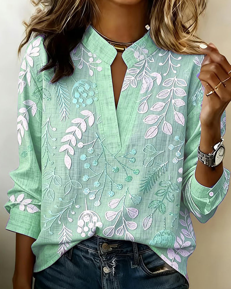BLUSA CON ESTAMPADO FLORAL Y CUELLO ALTO